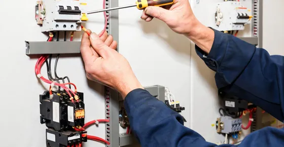 Electrical services in Dubai: electrician installing a wall socket in a home