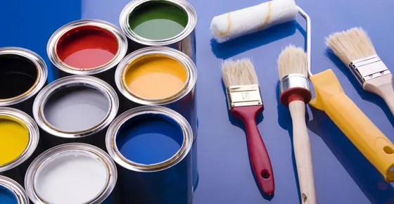 Painting services in Dubai: handyman painting an interior wall with a roller