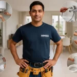 Indian handyman in HMSD uniform with tool belt showing plumbing services like faucet repair, water heater installation, and toilet fixing in Dubai.
